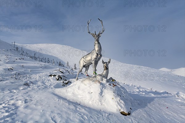 Deer monument on a snow covered mountain pass