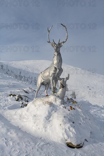 Deer monument on a snow covered mountain pass