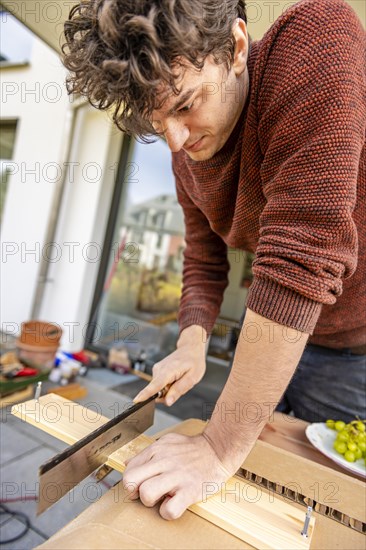 Young man doing DIY in his apartment