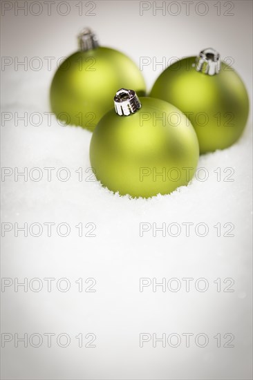 Beautiful matt green christmas ornaments on snow flakes room for your own text
