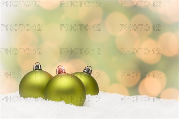 Beautiful matt green christmas ornaments on snow flakes over an abstract background with room for your own text