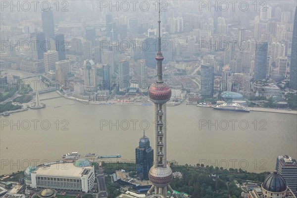 View from the highest observatory of the world on 562 meters height in the 632 meters high skyscraper Shanghai Tower on the special economic zone Pudong with the 468 meters high Oriental Pearl Tower t...