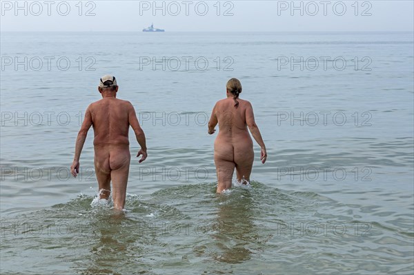 Elderly couple bathing naked
