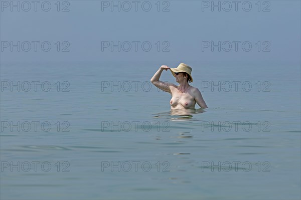 Older woman bathing naked
