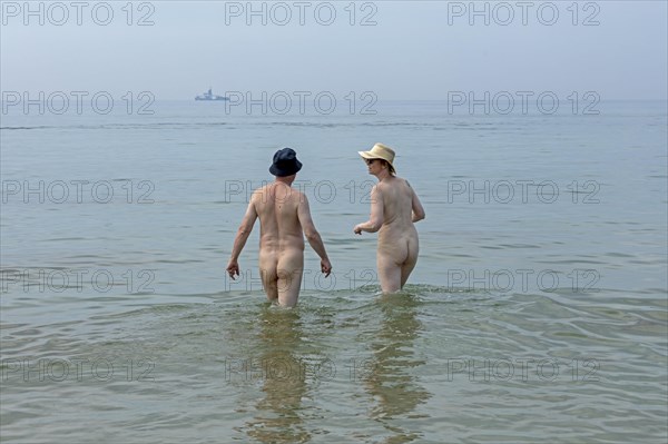 Elderly couple bathing naked
