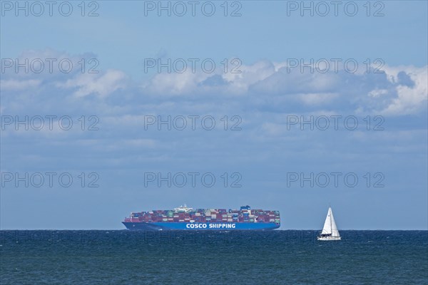 Container ship and sailing boat off Puttgarden