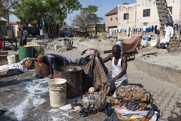 Man washing at the public wash area