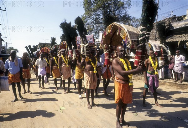 Devotees carrying Kavadi on their shoulders to Palani on Thai Poosam day