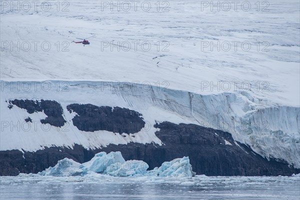 Helicopter flying over the giant icefield of Alexandra Land