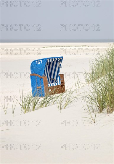 Beach chair with dunes at the beach