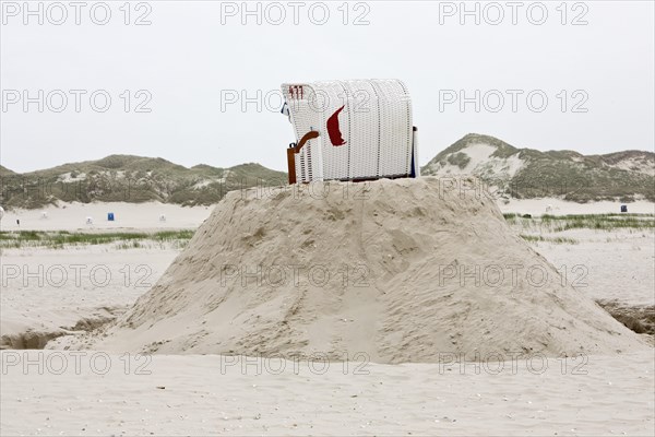 Beach chair on a built sand hill at the beach
