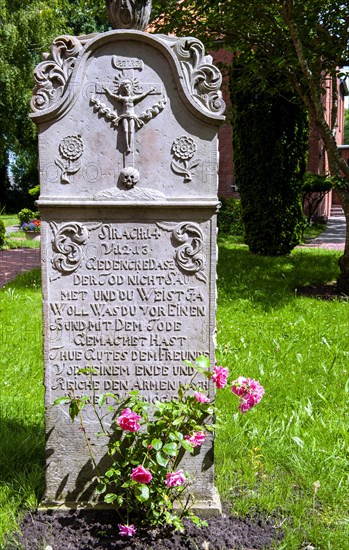 Historic sandstone gravestone from the 18th century in the churchyard of St. Nicholas Church