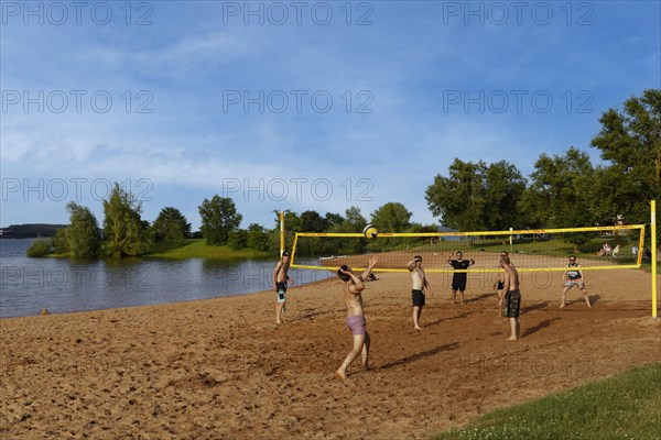 Men playing beach volleyball