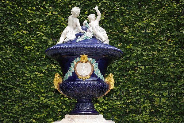 Ornamental glazed ceramic vessel with putti