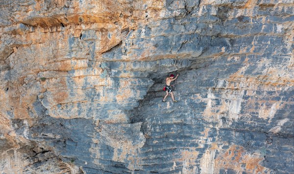 Climber climbing on a rock face