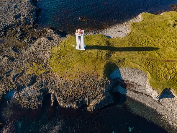 Lighthouse and coastal landscape with basalt formations