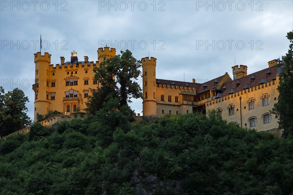 Illuminated castle Hohenschwangau in the evening light