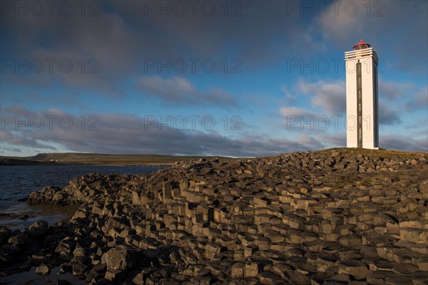 Lighthouse and coastal landscape with basalt formations