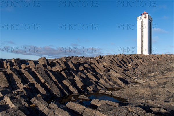 Lighthouse and coastal landscape with basalt formations