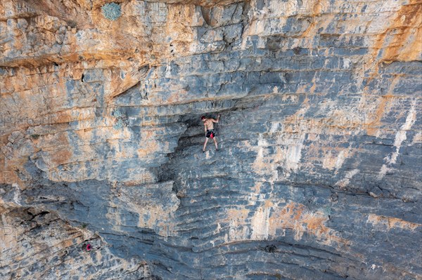 Climber climbing on a rock face
