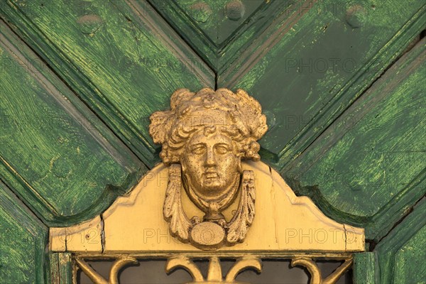 Old door knocker with woman's head