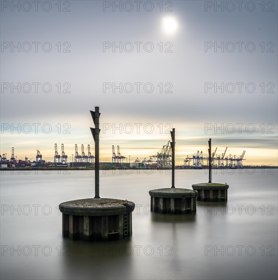 Long exposure of concrete bollards in the river Elbe at the port of Hamburg