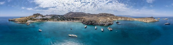 Sailboats anchoring in front of Lindos