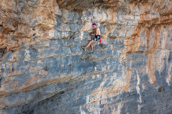 Climber climbing on a rock face