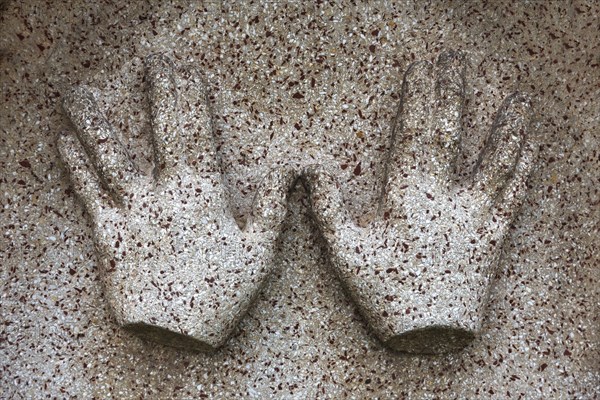 Symbol of blessing priest hands on a gravestone