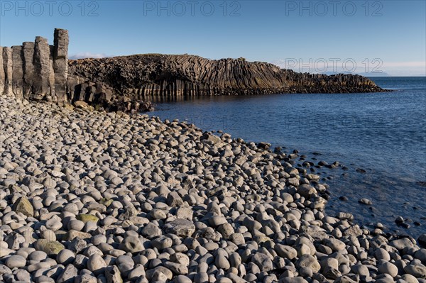 Basalt cliff and beach with rounded stones