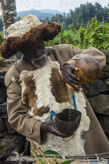 Old man preparing local herbs on a Ceremony of former poachers
