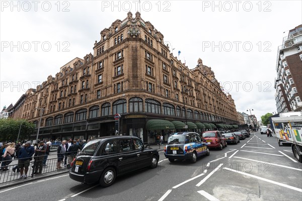 Taxis lined up on the street outside the luxury department stores