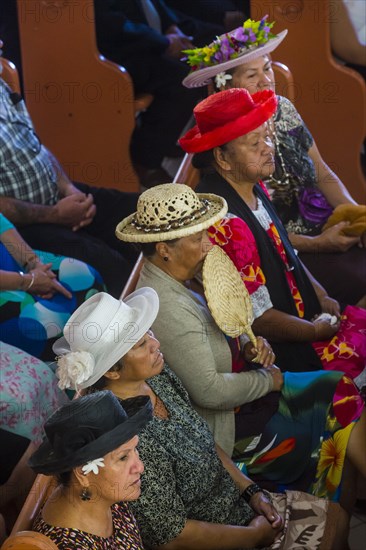 Women with traditional hats on a church service