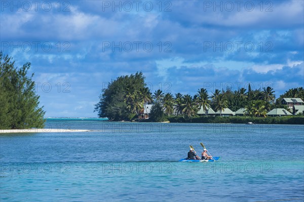 Couple kayaking in the waters of Muri beach