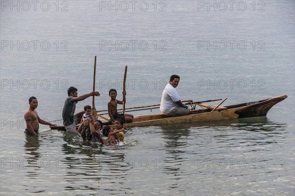 Loc boys having unin a canoe