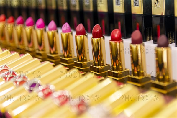 Lined up lipsticks in different shades of red