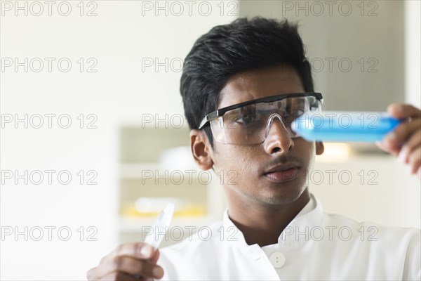 Student in an internship at the university with sample and lab coat