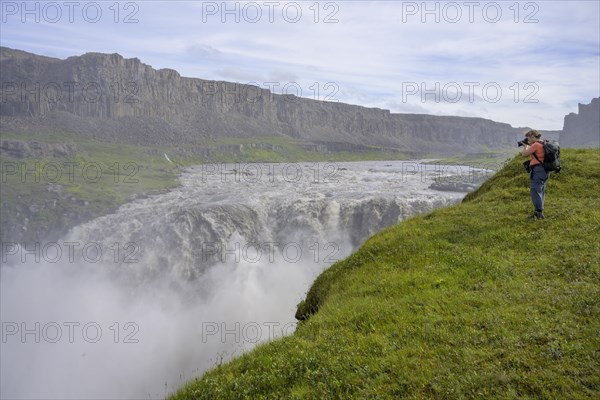 Woman photographing Hafragilsfoss