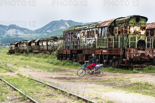 Motorcyclist crossing railway tracks