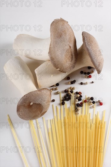 King trumpet mushrooms (Pleurotus eryngii) and peppercorns