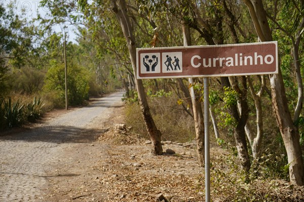 Paved road and town sign Curralinho