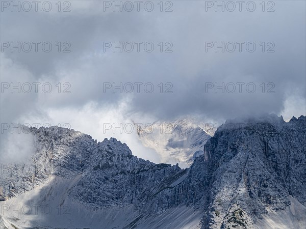 View from the Hafelekarspitze on misty mountain peaks in the Karwendel mountains