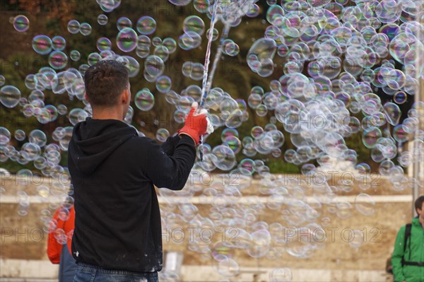 Man blowing soap bubbles