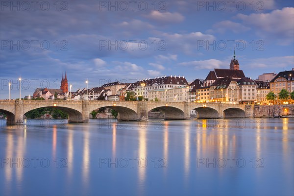 View of the old town of Basel illuminated at night with the Basel Cathedral