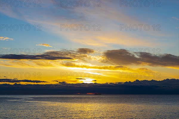 Sunrise behind dark clouds