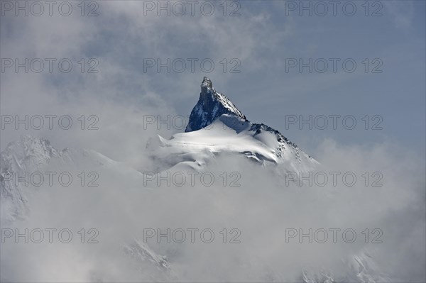 The Zinalrothorn peak rises out of the sea of clouds
