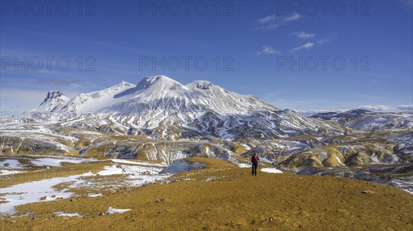 Woman in front of snowy mountains Loomundur Fannborg and Snaekollur in the hot spring area Hveradalir