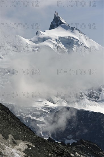 Peak Zinalrothorn rising from the sea of clouds