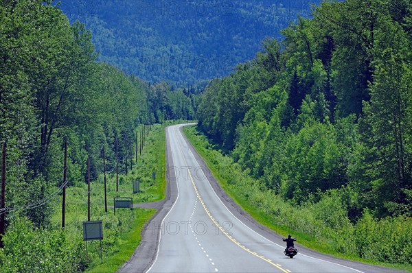 Motorcyclist on endless highway without traffic
