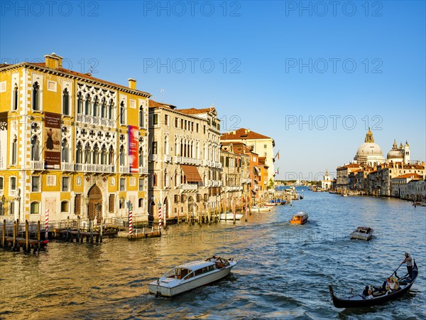 Gondola and boats next to Palazzo Franchetti Cavalli in the Grand Canal